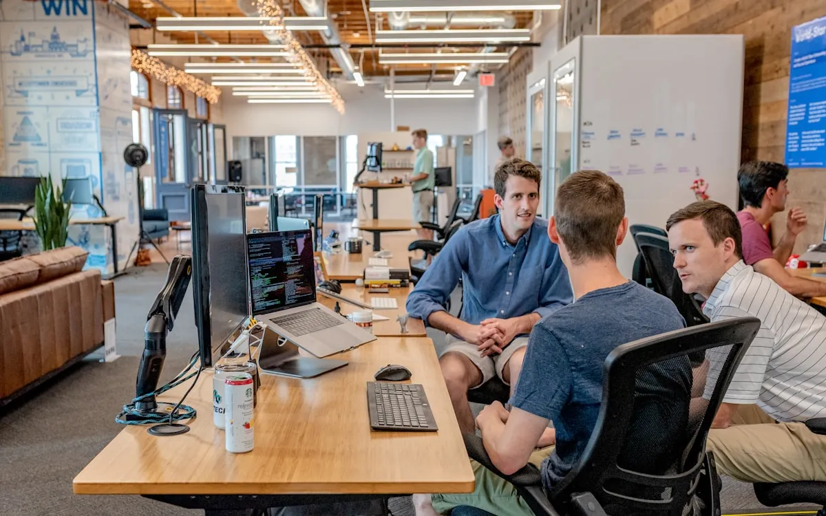 An engineering floor with a team working at desks and monitors.
