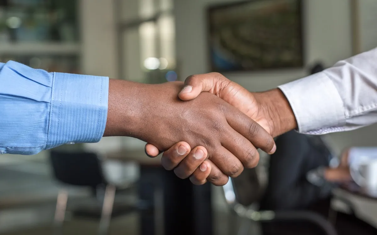 Two people shaking hands after a meeting.